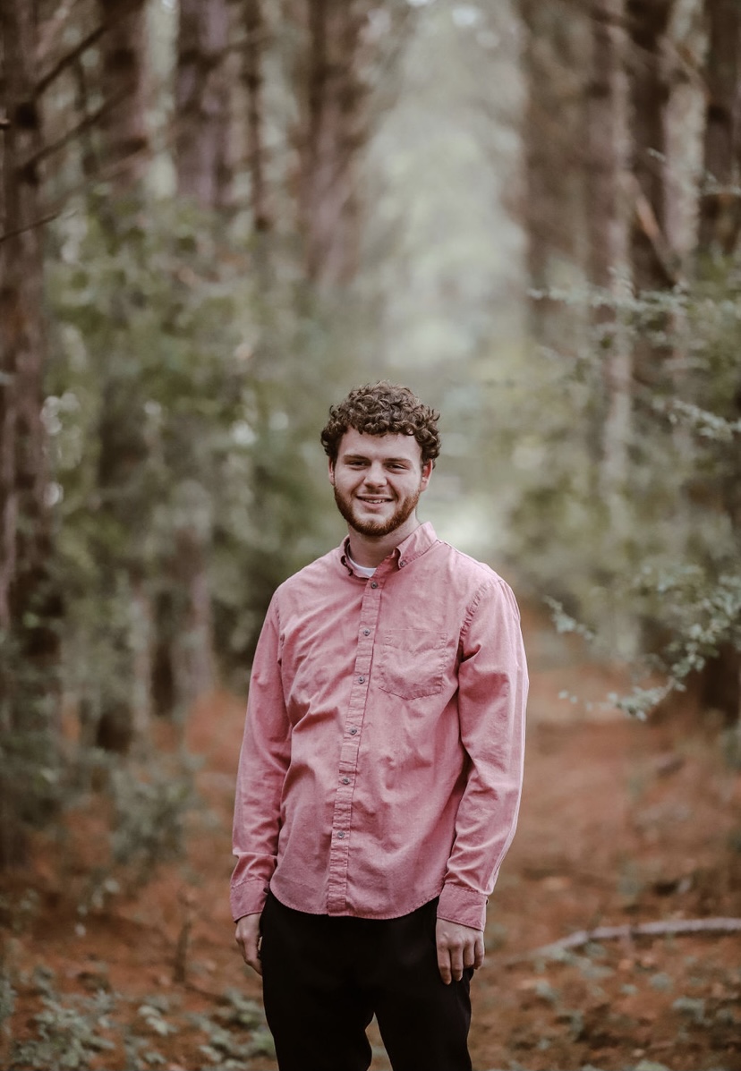 The owner of Pine Belt Tech standing on a trail in the Pine Belt woods